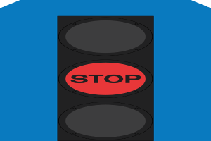 Eine Ampel, die ein rotes Stoppsignal gegen einen blauen Hintergrund anzeigt.